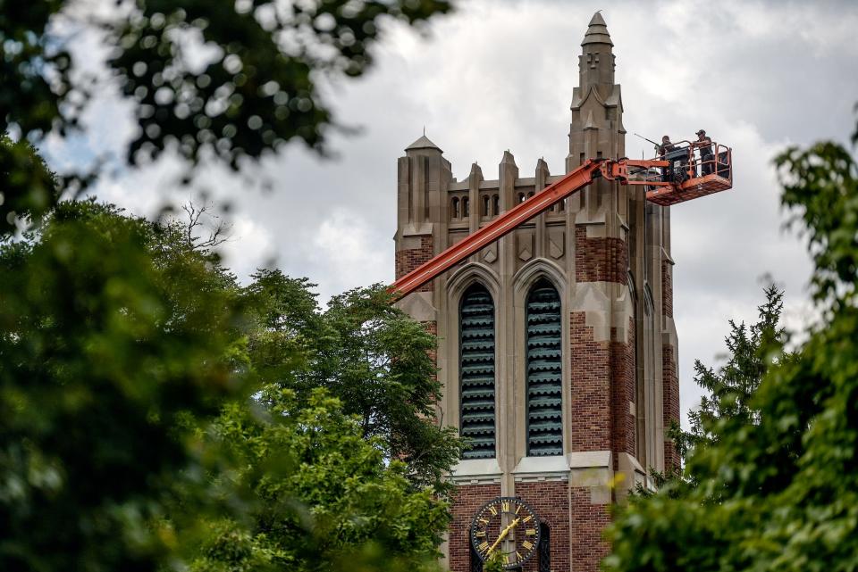 A crew from Michigan State University's Infrastructure Planning and Facilities department cleans the top of the Beaumont Tower with a power washer on Monday, Aug. 17, 2020, on campus in East Lansing.