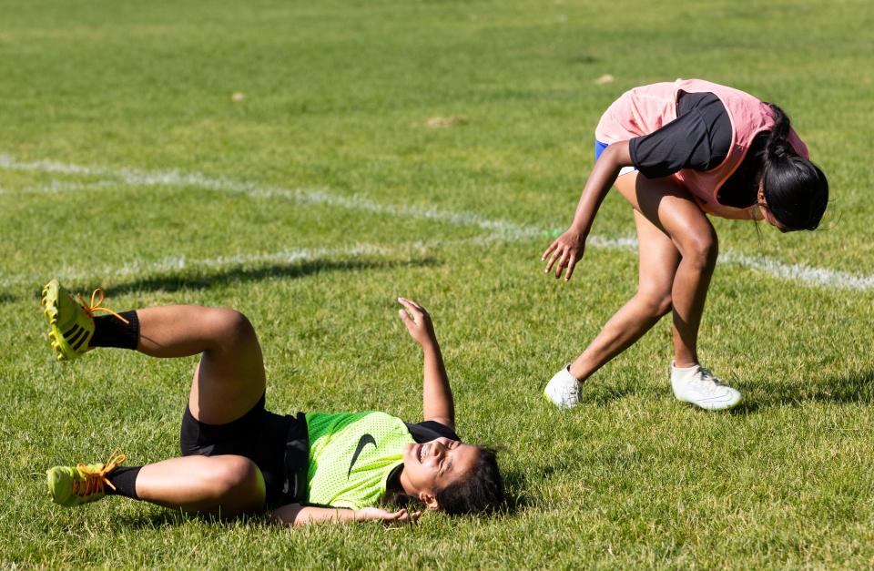Romisha Adhikari, of Nepal, left, and Anu Arumugarasa, of Sri Lanka, laugh during a scrimmage at their #SheBelongs soccer practice at Lone Peak Park in Sandy on Thursday, July 6, 2023. #SheBelongs is a four-month program bringing together refugee and nonrefugee girls through soccer. | Megan Nielsen, Deseret News