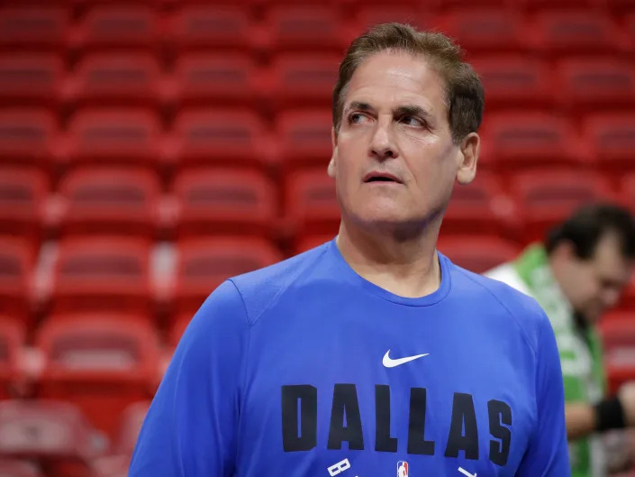 Dallas Mavericks owner Mark Cuban watches players warm up before the start of an NBA basketball game against the Miami Heat, Friday, Feb. 28, 2020, in Miami.