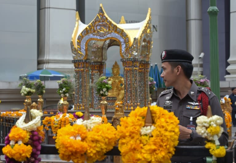 A Thai policeman stands guard at the Erawan shrine in Bangkok, on August 23, 2015