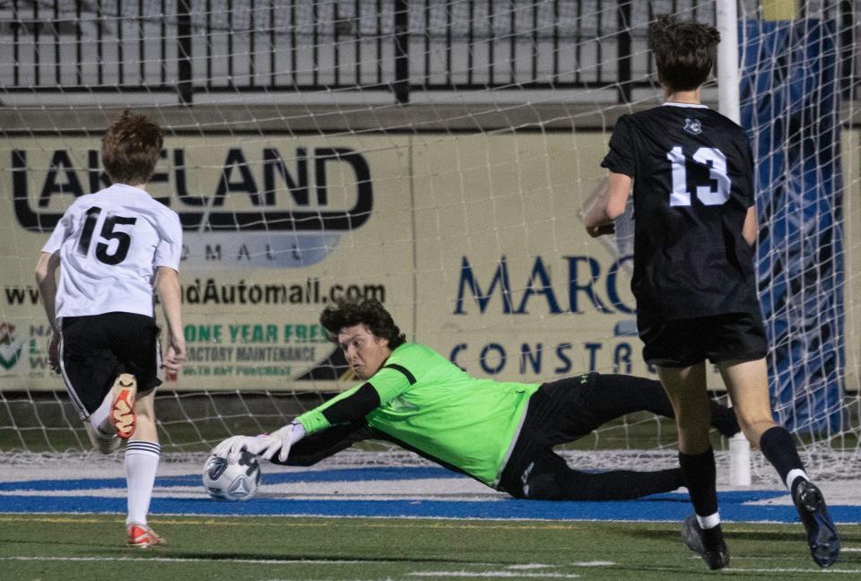 Lakeland Christian's Gray Ottman makes a diving save in front of Circle Christian's Knox Blevins on Friday night in the Class 2A, Region 7 semifinals at Viking Stadium.