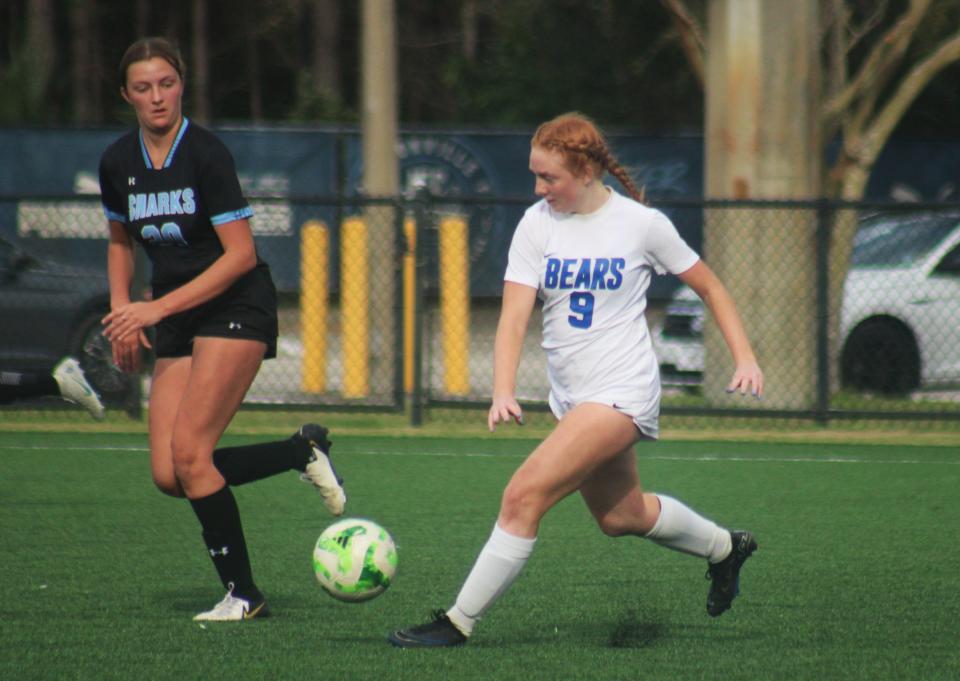 Bartram Trail fullback McKenzie Carlson (9) aims a pass during the Northeast Florida Senior All-Star Classic for girls soccer.
