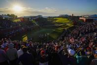 Players tee off on the first hole as the sun rises during a foursomes match the Ryder Cup at the Whistling Straits Golf Course Saturday, Sept. 25, 2021, in Sheboygan, Wis. (AP Photo/Ashley Landis)