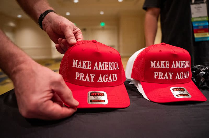 Hats with the slogan 'Make America Pray Again' are displayed at the 2024 National Religious Broadcasters Association International Christian Media Convention