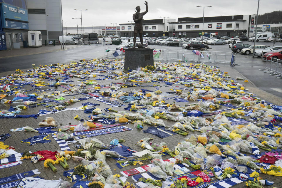 Tributes are placed outside the Cardiff City Stadium, Wales, for Emiliano Sala, Friday Feb. 8, 2019. Tributes are being paid across soccer to Argentine player Emiliano Sala, with the French league announcing a minute's applause before matches. French club Nantes says it will retire the No. 9 jersey worn by Sala before he was sold last month to Cardiff in the English Premier League. (Aaron Chown/PA via AP)