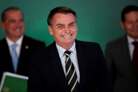 Brazil's President Jair Bolsonaro smiles during a signing ceremony of the decree which eases gun restrictions in Brazil, at the Planalto Palace in Brasilia, Brazil January 15, 2019. REUTERS/Ueslei Marcelino