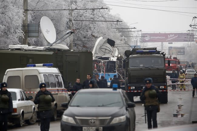 Military vehicles surround a wreckage of a trolleybus, in Volgograd, Russia, Monday, Dec. 30, 2013. A bomb blast tore through a trolleybus in the city of Volgograd on Monday morning, killing at least 10 people a day after a suicide bombing that killed at least 17 at the city's main railway station. Volgograd is about 650 kilometers (400 miles) northeast of Sochi, where the Olympics are to be held. (AP Photo/Denis Tyrin)