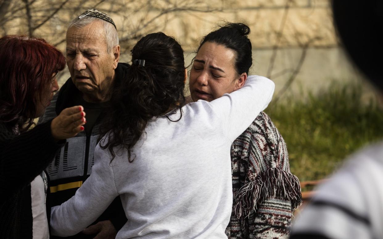 Relatives of Eli and Natali Mizrahi mourn at the scene of the mass shooting where the Israeli couple was killed near a synagogue in the Jerusalem neighbourhood of Neve Yaakov - Amir Levy/Getty Images