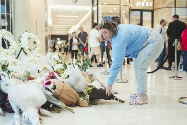 Une femme rend hommage aux victimes de l'attaque meurtrière du centre commercial Westfield Bondi Junction à Sydney lors de sa réouverture le 18 avril 2024, une semaine après le drame (Dion Georgopoulos)