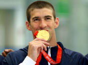 <b>Medal No. 10</b><br>Michael Phelps poses with the gold medal during the medal ceremony for the Men's 4x100m Freestyle Relay held at the National Aquatics Center on Day 3 of the Beijing 2008 Olympic Games on August 11, 2008 in Beijing, China.