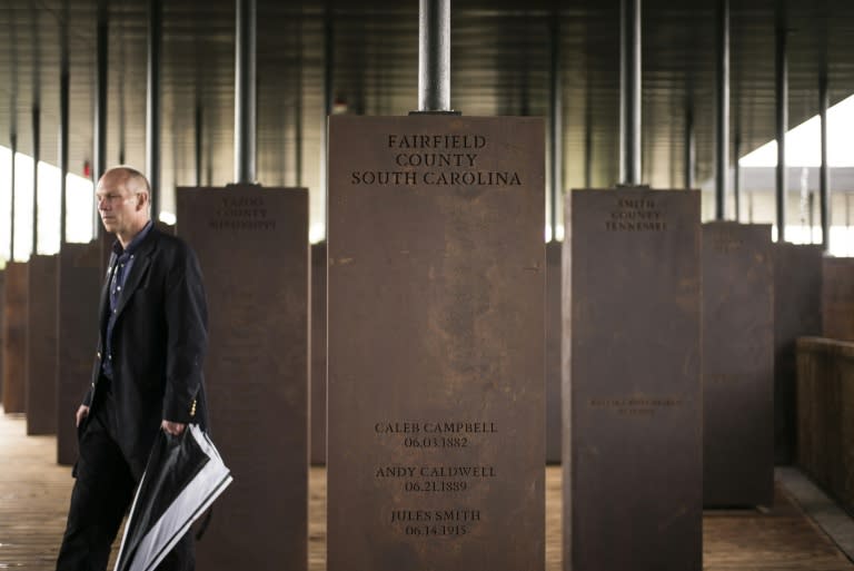 Markers display the names and locations of individuals killed by lynching at the National Memorial For Peace And Justice in Montgomery, Alabama