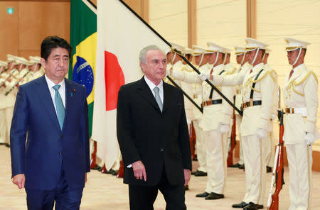 Brazil's President Michel Temer, right, accompanied by Japanese Prime Minister Shinzo Abe, reviews a guard of honor prior to their meeting at Abe's official residence in Tokyo, Oct. 19, 2016. REUTERS/Shizuo Kambayashi/Pool