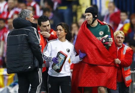 Chelsea's goal keeper Petr Cech walks past his manager Jose Mourihno as he is escorted off the pitch by the team doctor Eva Carneiro after being injured during their Champion's League semi-final first leg soccer match against Atletico Madrid at Vicente Calderon stadium in Madrid, April 22, 2014. REUTERS/Darren Staples