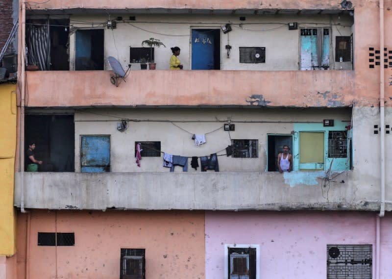 Residents are seen in their balconies during 21-day nationwide lockdown to limit the spreading of coronavirus disease (COVID-19), in New Delhi