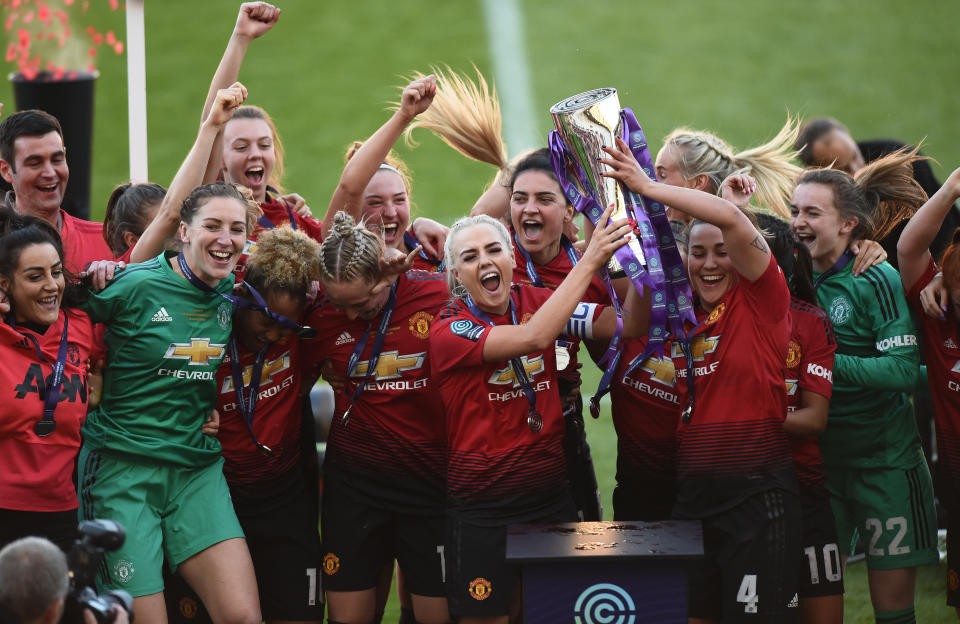 LEIGH, GREATER MANCHESTER - MAY 11: Manchester United players celebrate after they win  Women's Super League 2 trophy after the match between Manchester United Women and Lewes Women at Leigh Sports Village on May 11, 2019 in Leigh, Greater Manchester. (Photo by Nathan Stirk/Getty Images)