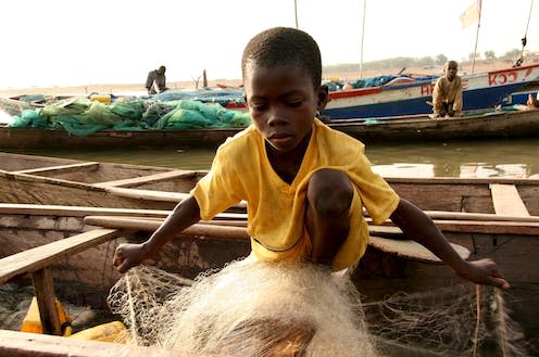 <span class="caption">One of thousands of young boys forced to work Ghana's fishing industry, often given to fishermen by their impoverished families.</span> <span class="attribution"><a class="link " href="https://webgate.epa.eu/webgate" rel="nofollow noopener" target="_blank" data-ylk="slk:Tugela Ridley/ EPA;elm:context_link;itc:0;sec:content-canvas">Tugela Ridley/ EPA</a></span>