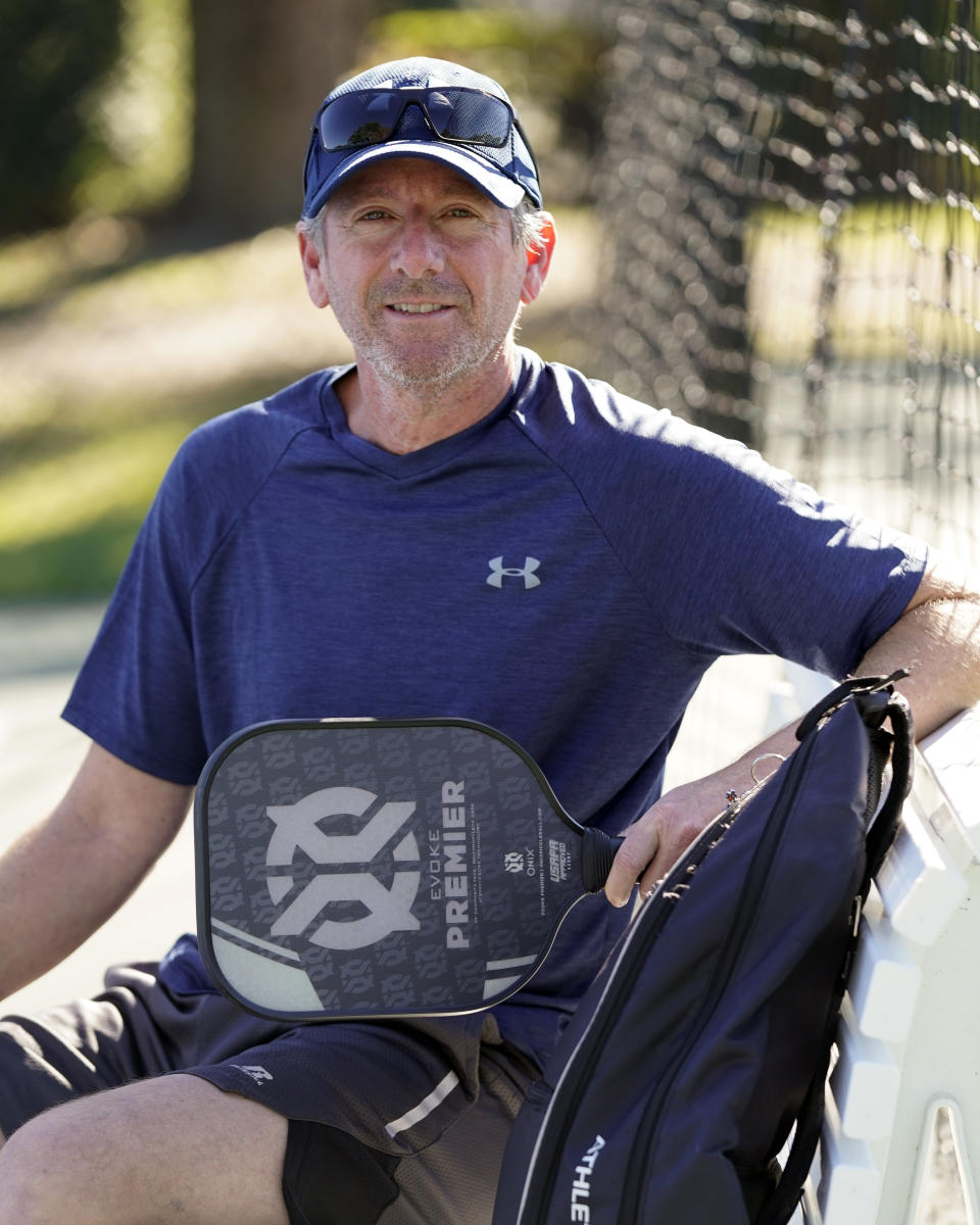 Owen Glick gets ready to play pickle ball at Phelps Park, Tuesday, Jan. 17, 2023, in Winter Park, Fla. Glick was among the 233,000 people who left a Western state for another U.S. state out of the region. The U.S. population center is on track this decade to take a southern swerve for the first time in history, and it's because of people like Glick, who moved from California to Florida more than a year ago. (AP Photo/John Raoux)