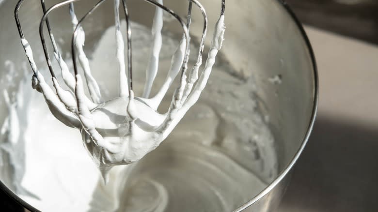 whisk covered with whipped cream