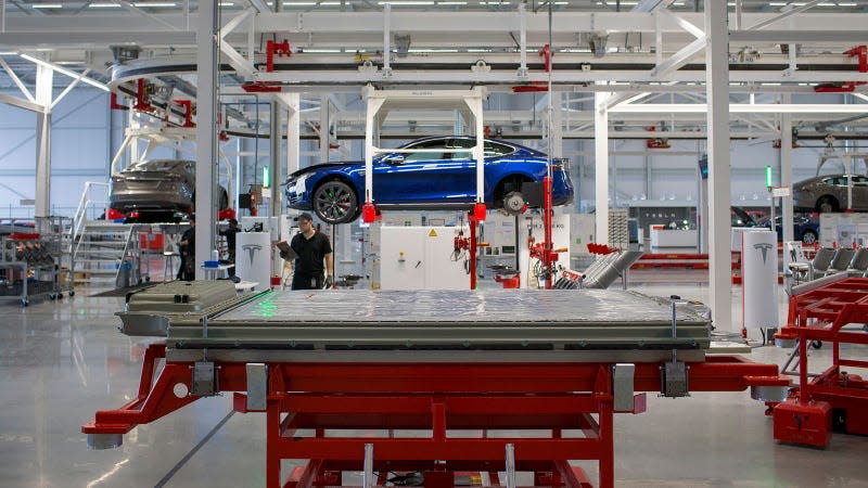 A photo of a Tesla on a production line. 