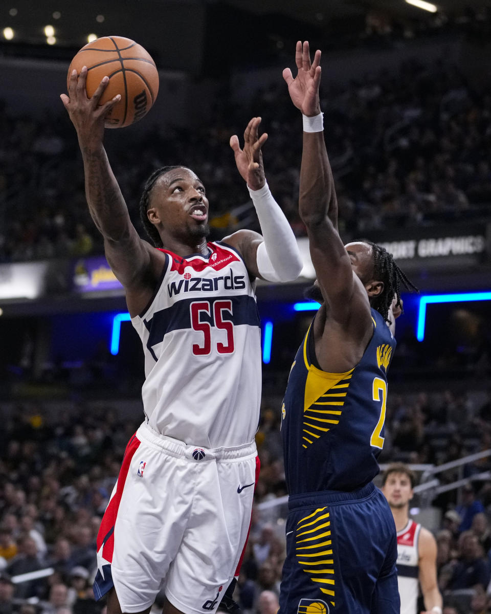 Washington Wizards guard Delon Wright (55) shoots over Indiana Pacers forward Aaron Nesmith (23) during the second half of an NBA basketball game in Indianapolis, Wednesday, Oct. 25, 2023. The Pacers defeated the Wizards 143-120. (AP Photo/Michael Conroy)