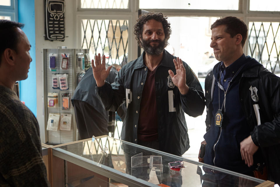 Andy Samberg cringes at a grinning Jason Mantzoukas