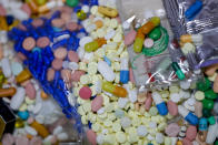 FILE - In this Sept. 11, 2019, file photo, medications slated for destruction are shown in a locked storage area of the police department in Barberton, Ohio. Even as the coronavirus outbreak and the Trump administration's response to the pandemic have been a dominating theme in this year's presidential race, Ohio, a battleground state in the presidential contest, is on track to have one of its deadliest years of opioid drug overdoses. (AP Photo/Keith Srakocic, File)