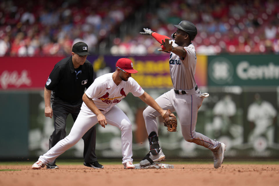 Miami Marlins' Jesus Sanchez, right, is safe at second ahead of the tag from St. Louis Cardinals shortstop Paul DeJong after hitting a two-run single during the third inning of a baseball game Wednesday, July 19, 2023, in St. Louis. Sanchez went on to second on the throw. (AP Photo/Jeff Roberson)