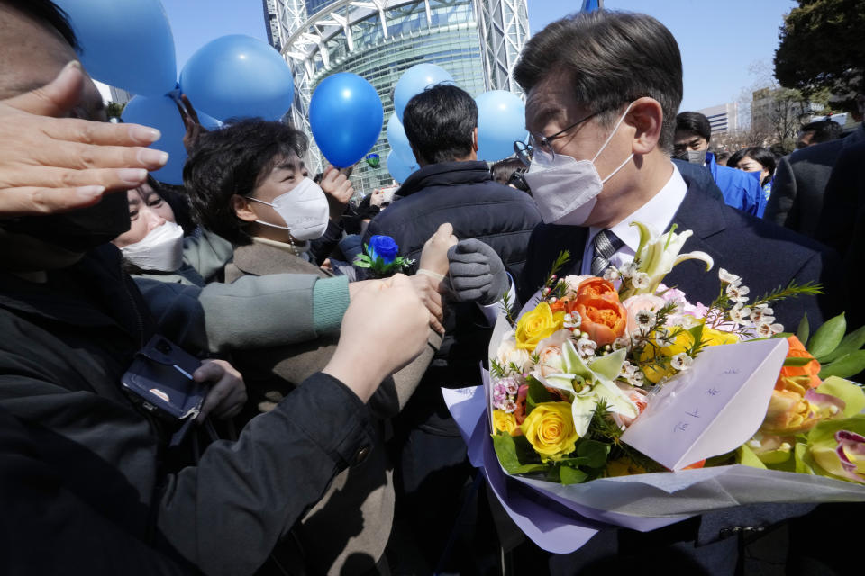 Lee Jae-myung, the presidential candidate of the ruling Democratic Party, is greeted by supporters during a presidential election campaign in Seoul, South Korea on March 3, 2022. Just days before March 9 election, Lee and Yoon Suk Yeol from the main conservative opposition People Power Party are locked in an extremely tight race. (AP Photo/Ahn Young-joon)
