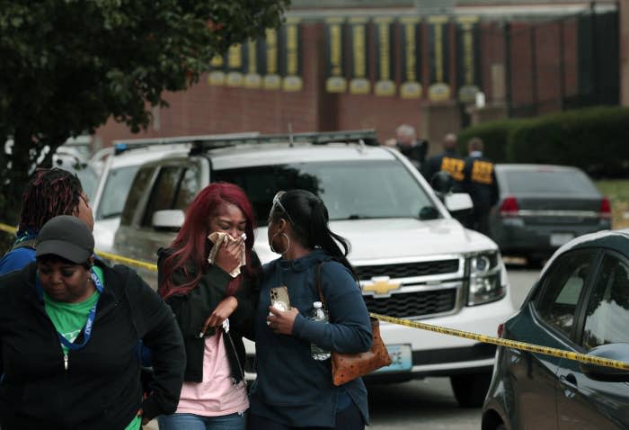 A friend of the student killed in a school shooting at Central Visual and Performing Arts High School is helped while leaving the school grounds on Oct. 24, 2022, in the Southwest Garden neighborhood of St. Louis.