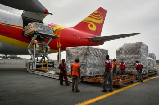 Workers unload medicines and disposable medical supplies from a Chinese 747 cargo plane after it landed at Simon Bolivar International Airport on March 29, 2019