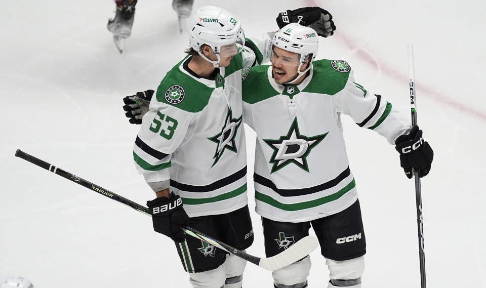 Dallas Stars center Wyatt Johnston, left, congratulates center Logan Stankoven after he scored a goal in the first period of an NHL hockey game against the Colorado Avalanche Tuesday, Feb. 27, 2024, in Denver. (AP Photo/David Zalubowski)