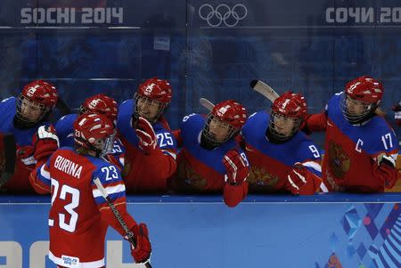 Russian players celebrate after scoring on Japan during the first period of their women's ice hockey game at the 2014 Sochi Winter Olympics, February 11, 2014. REUTERS/Grigory Dukor