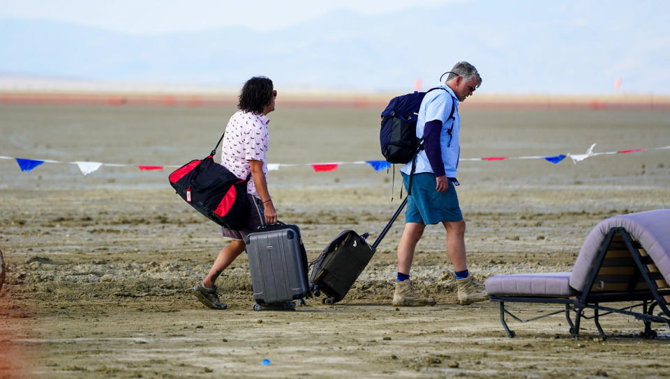 People walk towards the city limits of Burning Man in Black Rock Desert, Nev., on Sept. 3, 2023. (Trevor Hughes / USA TODAY Network via Reuters)