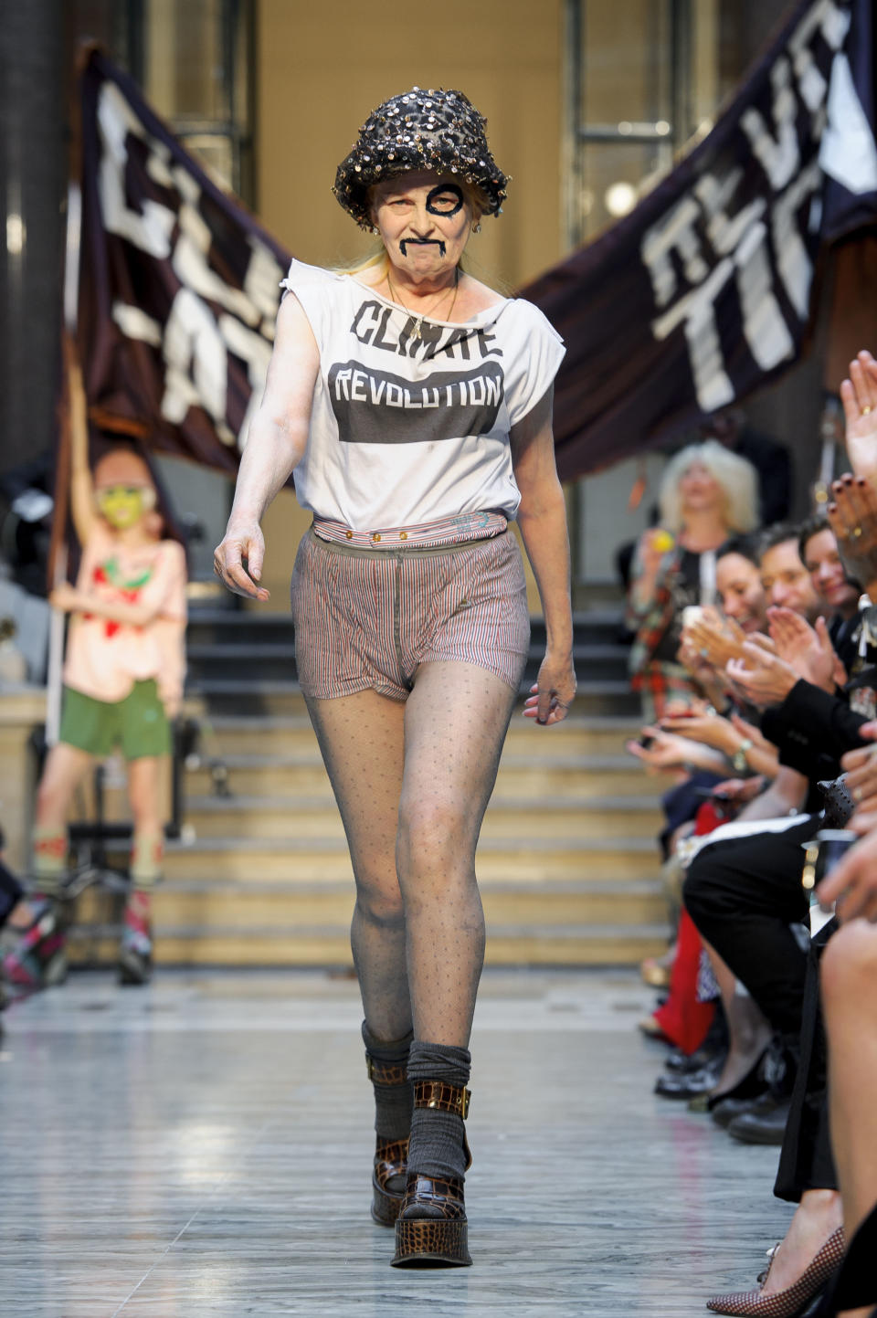 British designer Vivienne Westwood receives applause during London Fashion Week, Sunday, Sept. 16, 2012. (AP Photo/Jonathan Short)