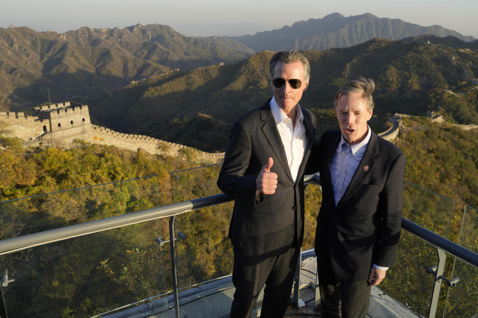 California Gov. Gavin Newsom, left, poses for photos with U.S. ambassador to China Nicholas Burns during a visit to the Mutianyu Great Wall on the outskirts of Beijing, Thursday, Oct. 26, 2023. Newsom is on a weeklong tour of China where he is pushing for climate cooperation. His trip as governor, once considered routine, is drawing attention as it comes after years of heightening tensions between the U.S. and China. (AP Photo/Ng Han Guan)