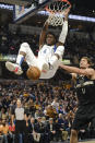 Indiana Pacers guard Victor Oladipo (4) dunks in front of Milwaukee Bucks center Brook Lopez (11) during the first half of an NBA basketball game in Indianapolis, Wednesday, Feb. 12, 2020. (AP Photo/AJ Mast)