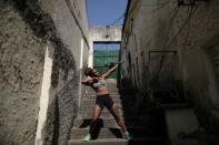 Dayelle dos Santos, 17, who trains in Mangueira Olympic Village, poses outside her house in Mangueira slum in Rio de Janeiro, Brazil, August 16, 2016. REUTERS/Ricardo Moraes