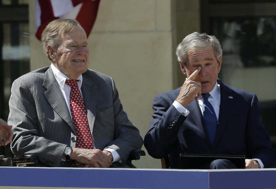 Former president George W. Bush, wipes a tear after his speech during the dedication of the George W. Bush presidential library on Thursday, April 25, 2013, in Dallas. Left is President George H.W. Bush. (AP Photo/David J. Phillip)