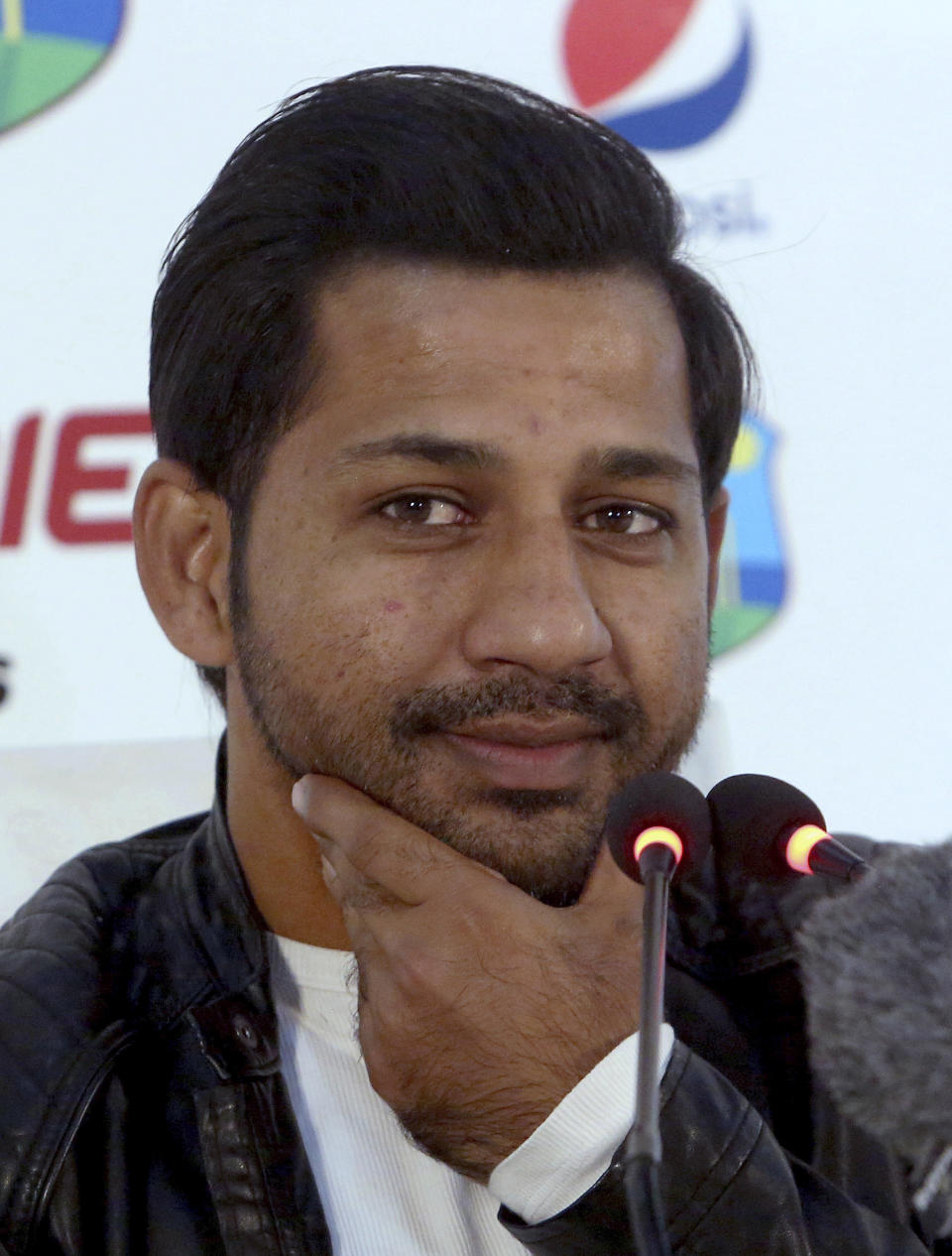 Pakistan's banned captain Sarfraz Ahmed listens to a reporter during a press conference in Karachi, Pakistan, Sunday, Feb. 3, 2019. Ahmed hopes his four-match suspension will not deny him from leading the country in the World Cup in England later this year. (AP Photo/Fareed Khan)