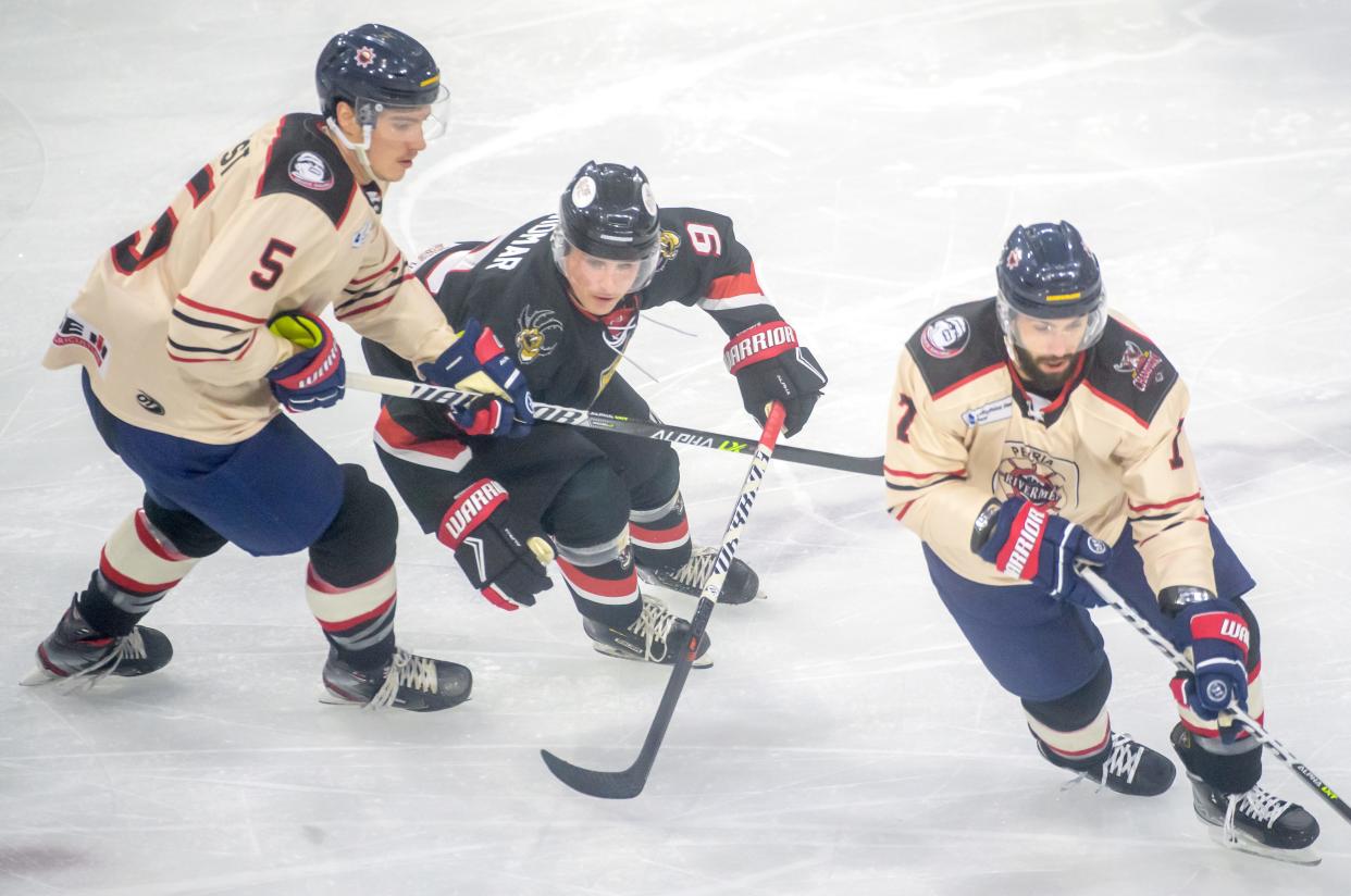 Peoria's Cale List (5) slows down Vermilion County's Ryan Widmar (9) as teammate Joseph Drapluk moves the puck in the first period Friday, Jan. 6, 2023 at Carver Arena. The Rivermen fell to the Bobcats 4-2.