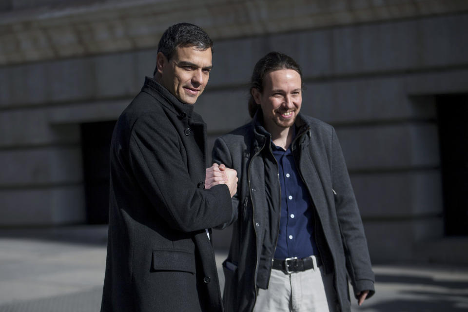 FILE - In this March 30, 2016 file photo, Spain's Socialist Party leader Pedro Sanchez, left, shakes hands with the United Podemos (United We Can) party leader Pablo Iglesias for the media as they arrive to the Spanish Parliament before their talks in Madrid. Spain's center-left Socialist party and the United We Can party are edging closer to a deal on forming a coalition government, Friday July 19, 2019, after Iglesias removed a key obstacle to an agreement by saying he will not insist on being part of a future Cabinet. (AP Photo/Francisco Seco, File)