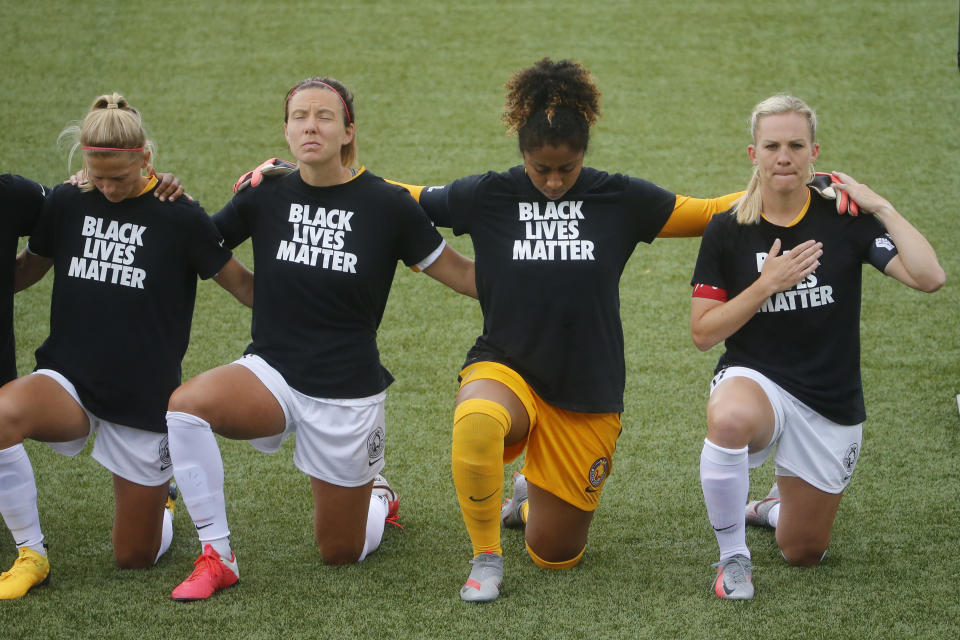 Players for the Utah Royals FC take a knee for the national anthem prior to their game against the Houston Dash during NWSL Challenge Cup at Zions Bank Stadium Tuesday, June 30, 2020, Herriman, Utah. (AP Photo/Rick Bowmer)