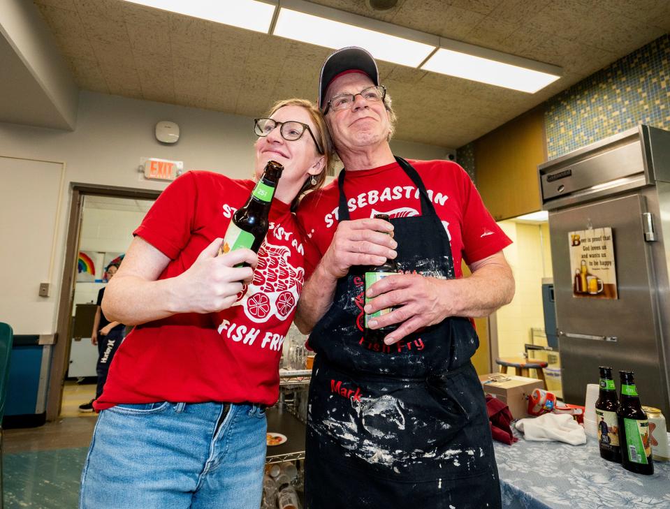 Organizers Liz Martin and Mark Krier celebrate the end of the evening at the St. Sebastian Parish fish fry with a beer.