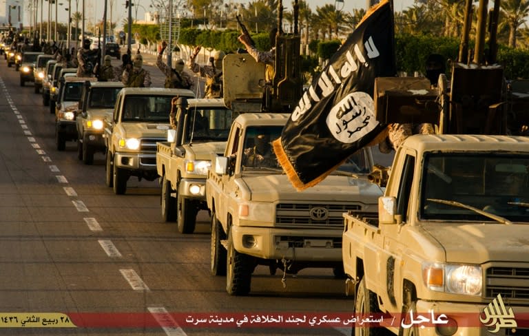 Members of the Islamic State militant group parade a street in Libya, in this image provided by Islamist media outlet Welayat Tarablos