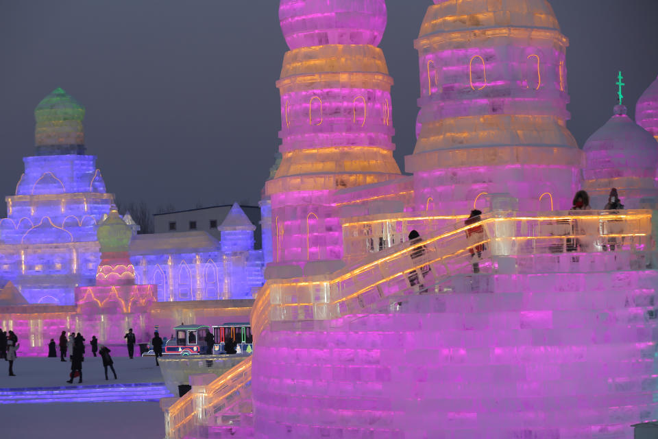 <p>People visit the ice sculptures illuminated by colored lights for the 34th Harbin International Ice and Snow Sculpture Festival on Jan. 4. (Photo: Wu Hong/EPA-EFE/REX/Shutterstock) </p>