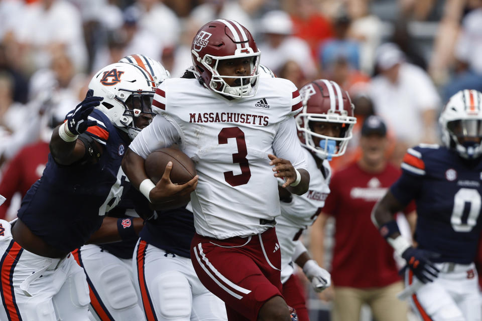 Massachusetts quarterback Taisun Phommachanh (3) carries the ball as Auburn linebacker Austin Keys (6) brings him down from behind during the first half of an NCAA college football game Saturday, Sept. 2, 2023, in Auburn, Ala. (AP Photo/Butch Dill)