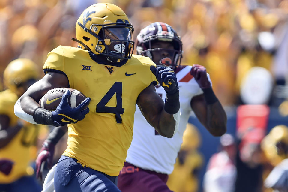 West Virginia running back Leddie Brown (4) rushes for a touchdown against Virginia Tech during the first half of an NCAA college football game in Morgantown, W.Va., Saturday, Sept. 18, 2021. (AP Photo/William Wotring)