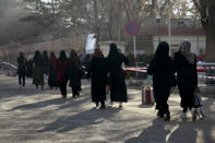 Afghan students walk toward their university in Kabul, Afghanistan, Saturday, Feb. 26, 2022. Kabul University, among Afghanistan’s oldest and most revered institutions of higher education, reopened Saturday six months after the Taliban retook the country. There were new restrictions in place, however, including gender segregation and mandatory Islamic dress. (AP Photo/Hussein Malla)