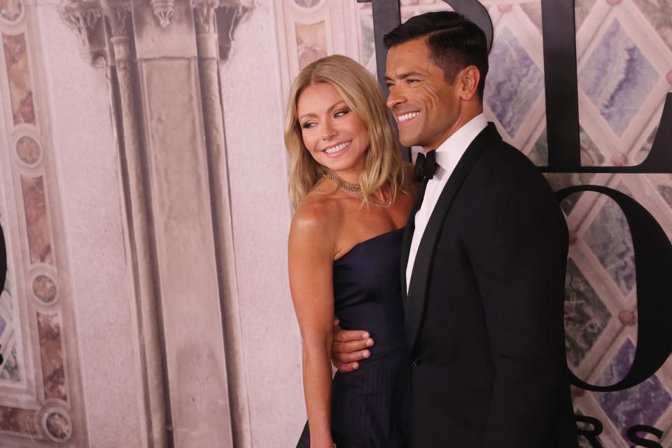 Kelly Ripa and Mark Consuelos pose at an event