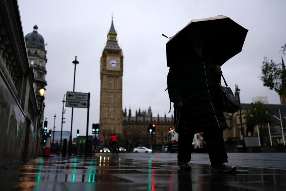 Commuters with umbrellas on a rainy morning in Westminster, London. (PA)